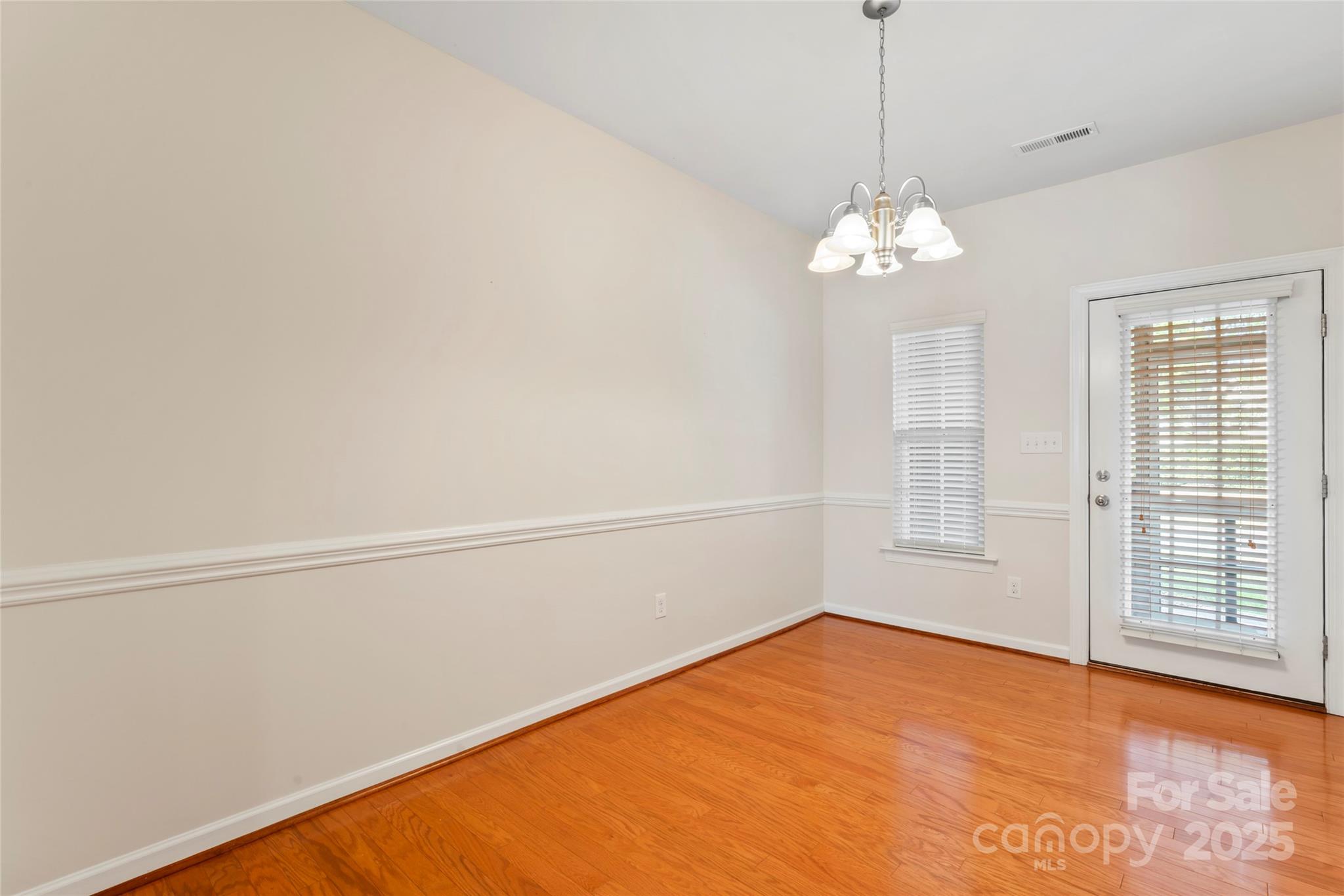 5678 Stafford Road Charlotte, NC 28215 - Photo 18 of 43 a view of empty room with wooden floor and fan