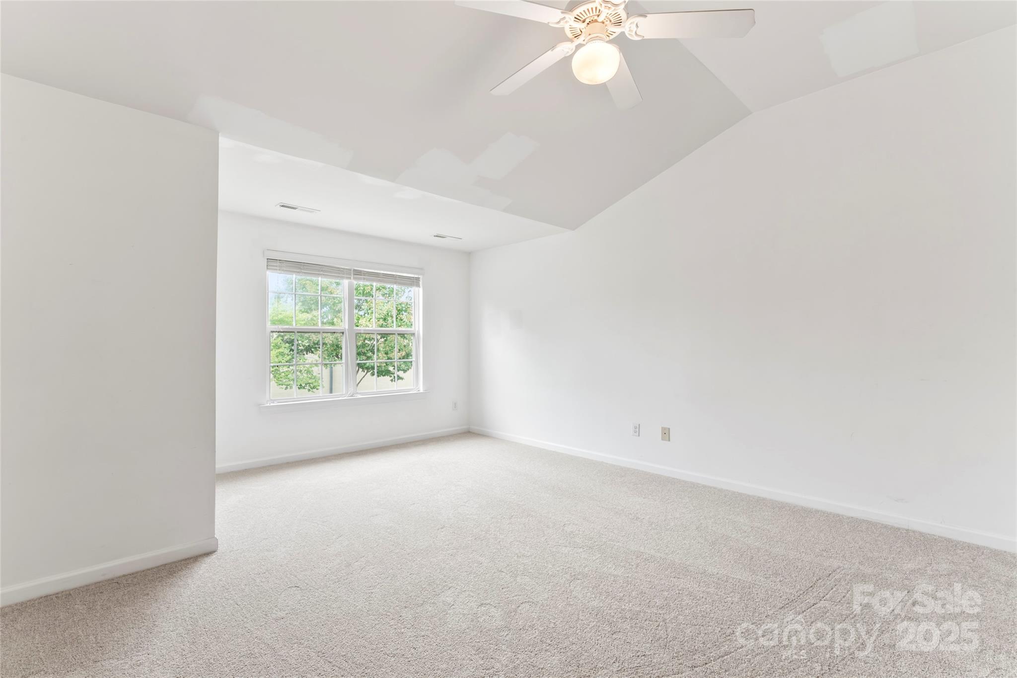 5678 Stafford Road Charlotte, NC 28215 - Photo 31 of 43 an empty room with a chandelier fan and windows