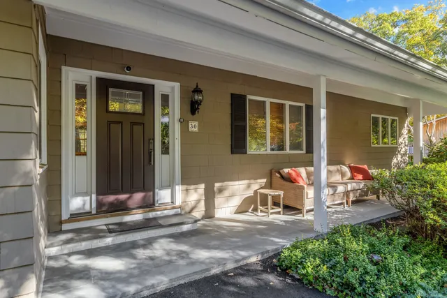 a front view of a house with a garden