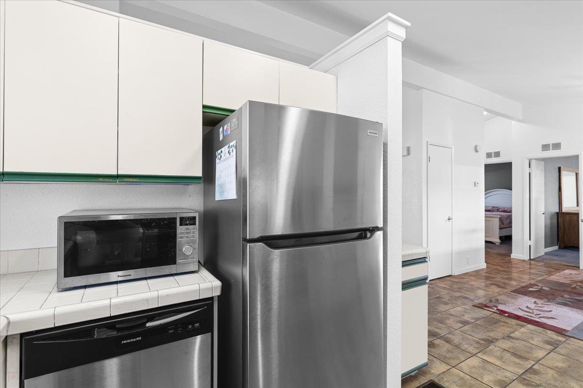 1500 Held Drive, Unit 79 Modesto, CA 95355 - Photo 15 of 58 a kitchen with a refrigerator stove and cabinets