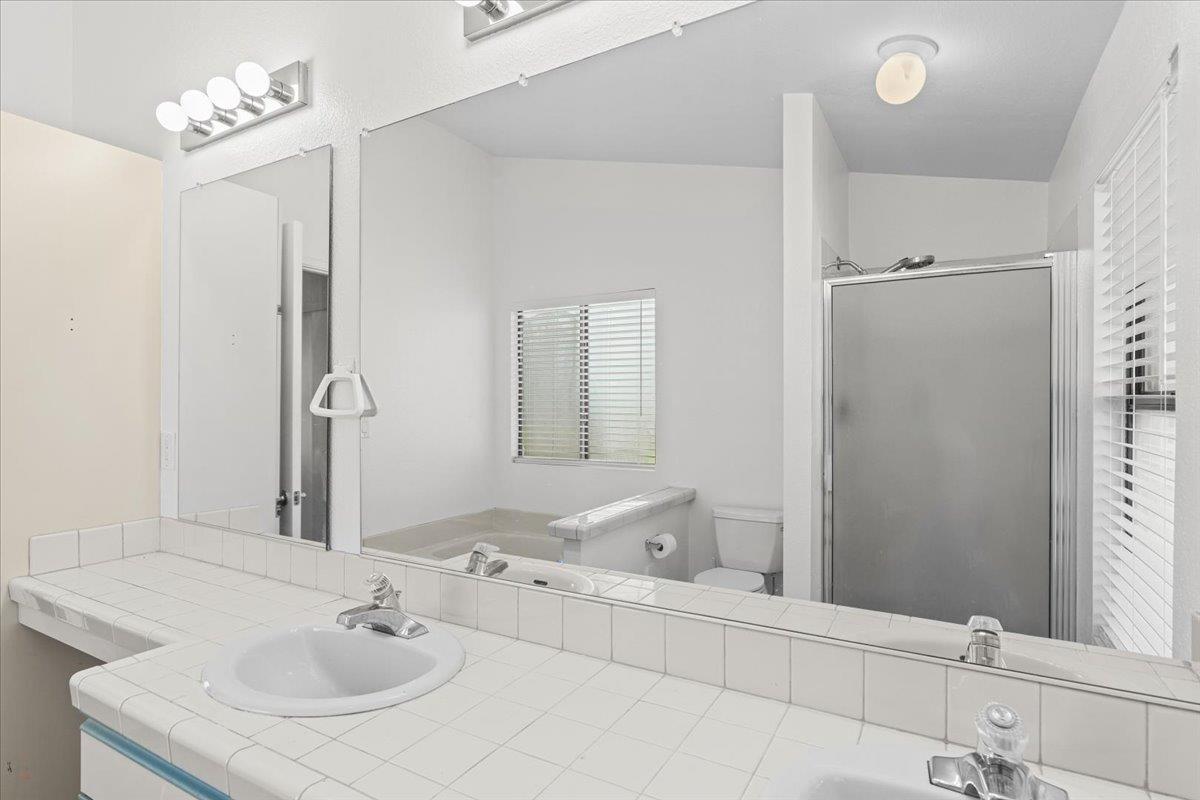 1500 Held Drive, Unit 79 Modesto, CA 95355 - Photo 25 of 58 a bathroom with a sink and a mirror