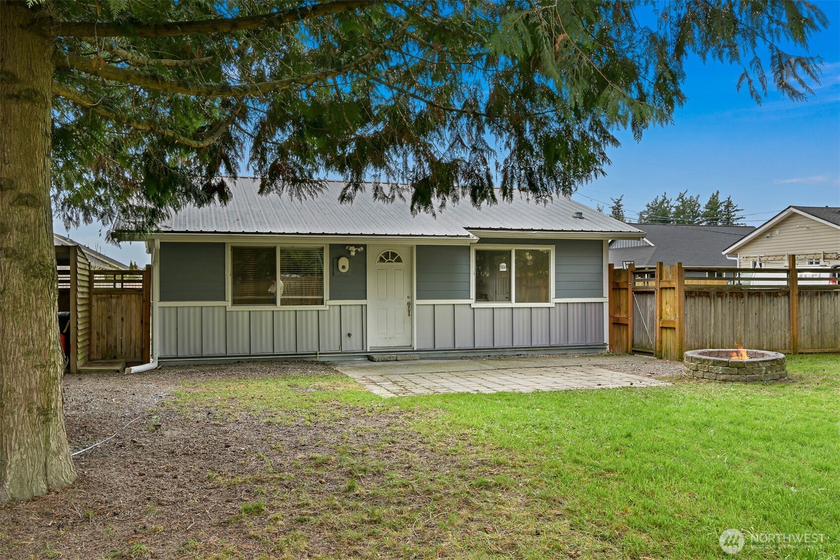 a view of a house with a yard and sitting area