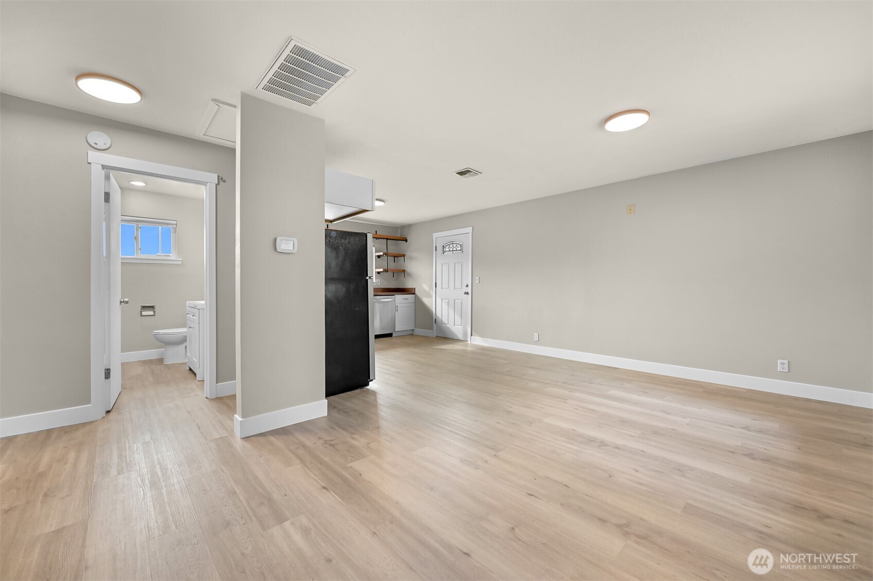 310 West 3rd Street Nooksack, WA 98276 - Photo 14 of 34 a view of a room with wooden floor and a bathroom