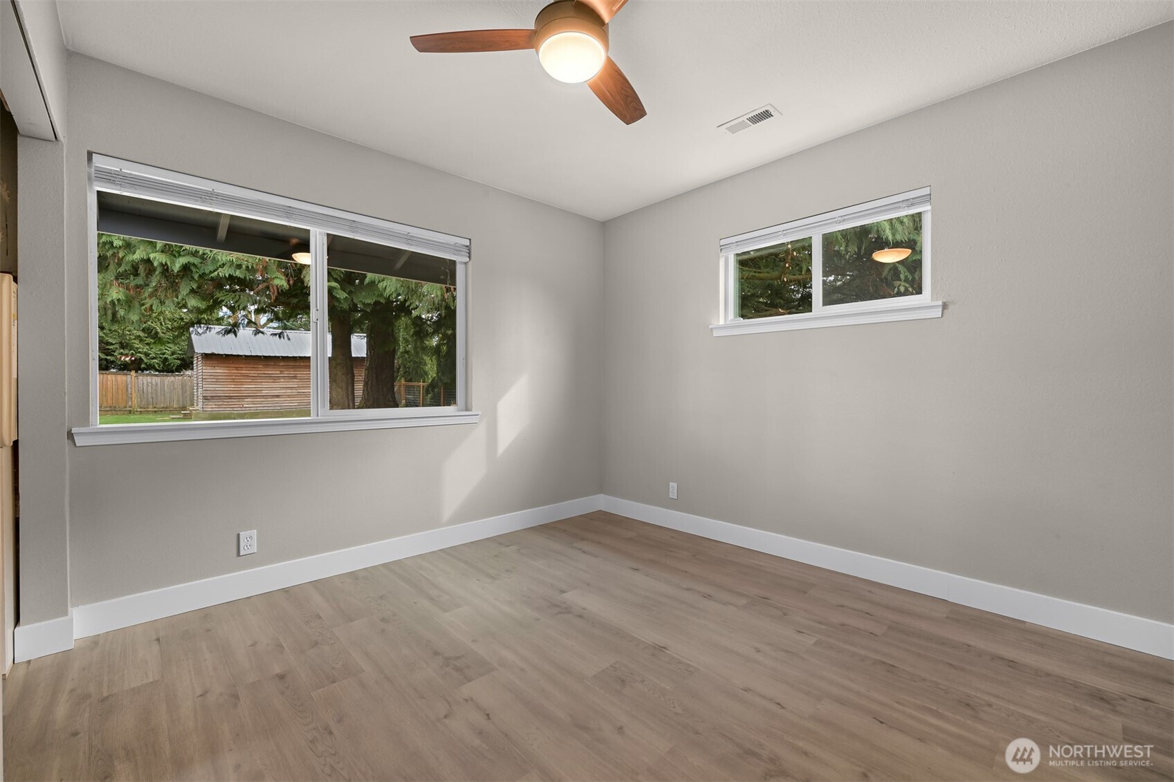 310 West 3rd Street Nooksack, WA 98276 - Photo 16 of 34 a view of an empty room with wooden floor and a window