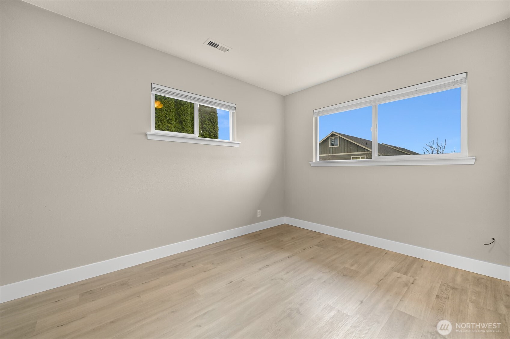 310 West 3rd Street Nooksack, WA 98276 - Photo 22 of 34 a view of a room with wooden floor and wall painting