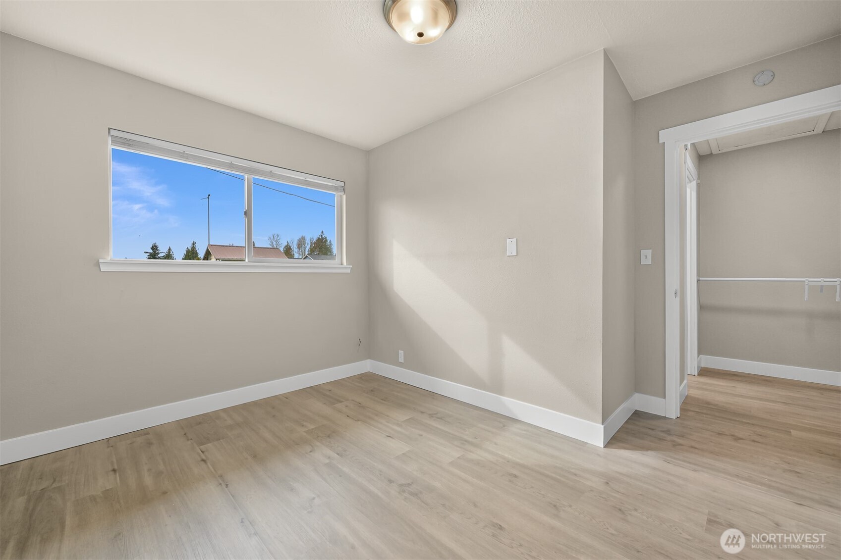 310 West 3rd Street Nooksack, WA 98276 - Photo 23 of 34 a view of an empty room with wooden floor and a window