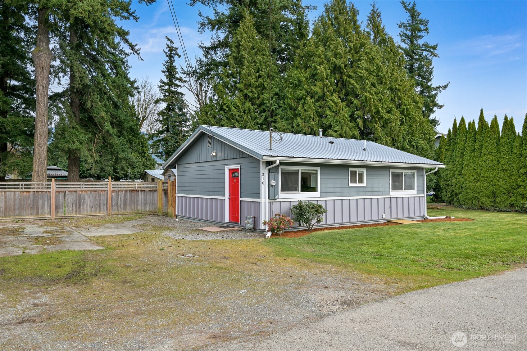 310 West 3rd Street Nooksack, WA 98276 - Photo 3 of 34 a view of a house with a yard and fence