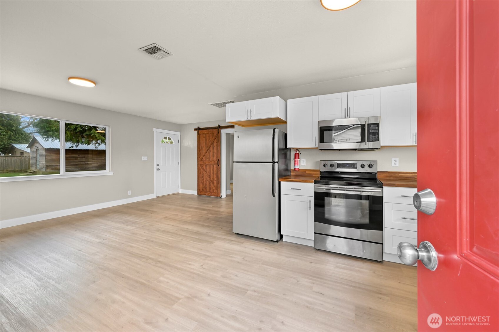 310 West 3rd Street Nooksack, WA 98276 - Photo 6 of 34 a kitchen with stainless steel appliances a refrigerator stove and microwave