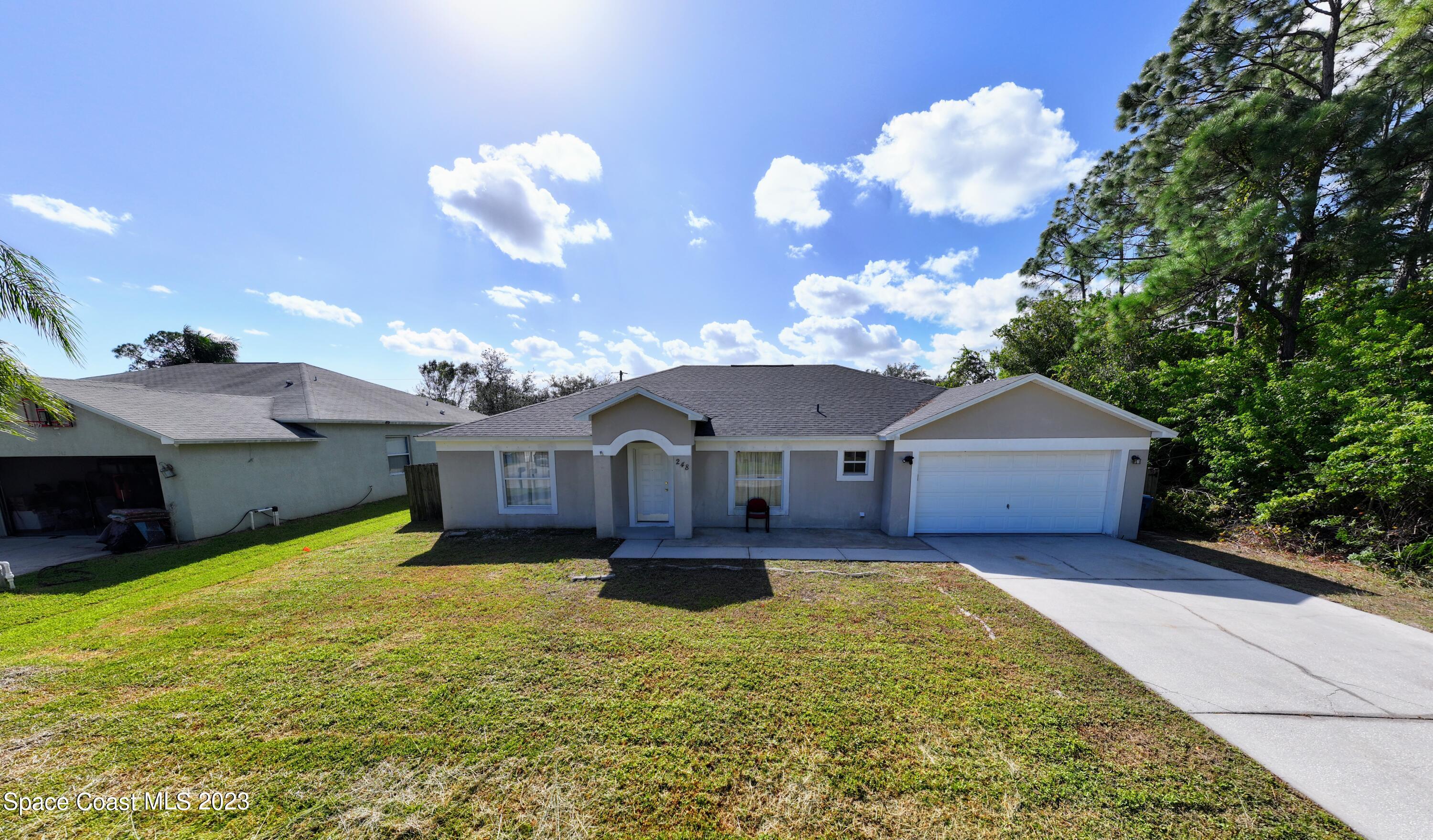 248 Benchor Road Northwest Palm Bay, FL 32907 - Photo 1 of 31 a view of a house with a yard and large tree