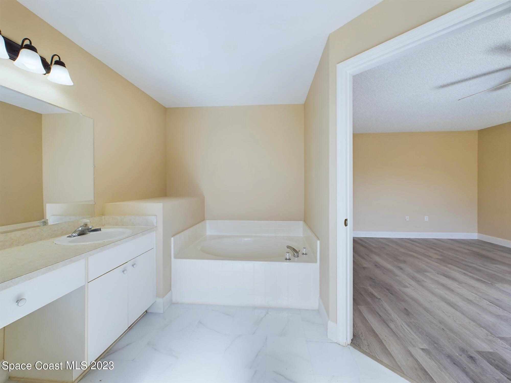248 Benchor Road Northwest Palm Bay, FL 32907 - Photo 15 of 31 a bathroom with a tub sink and mirror