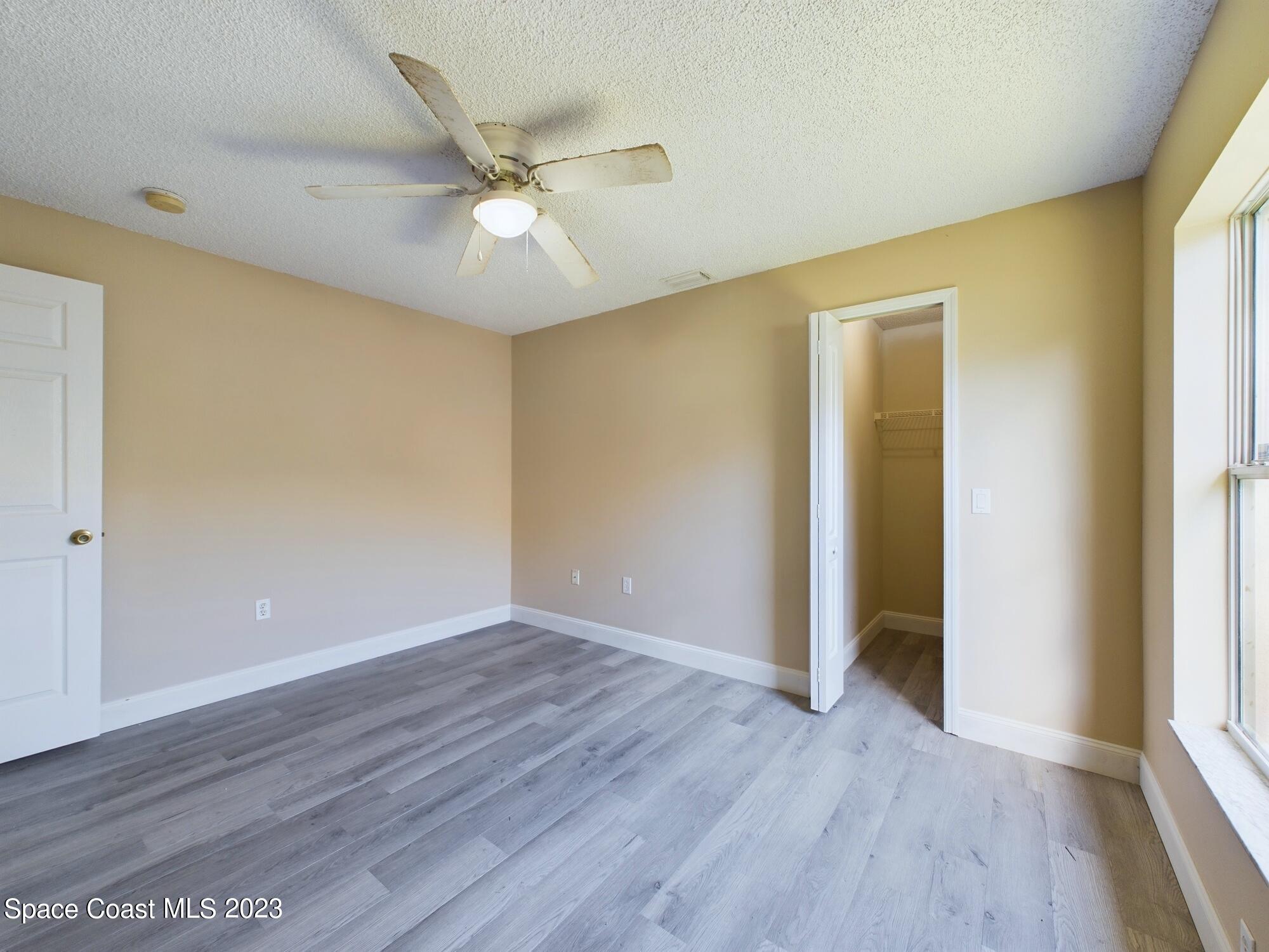 248 Benchor Road Northwest Palm Bay, FL 32907 - Photo 19 of 31 a view of an empty room with wooden floor and a window