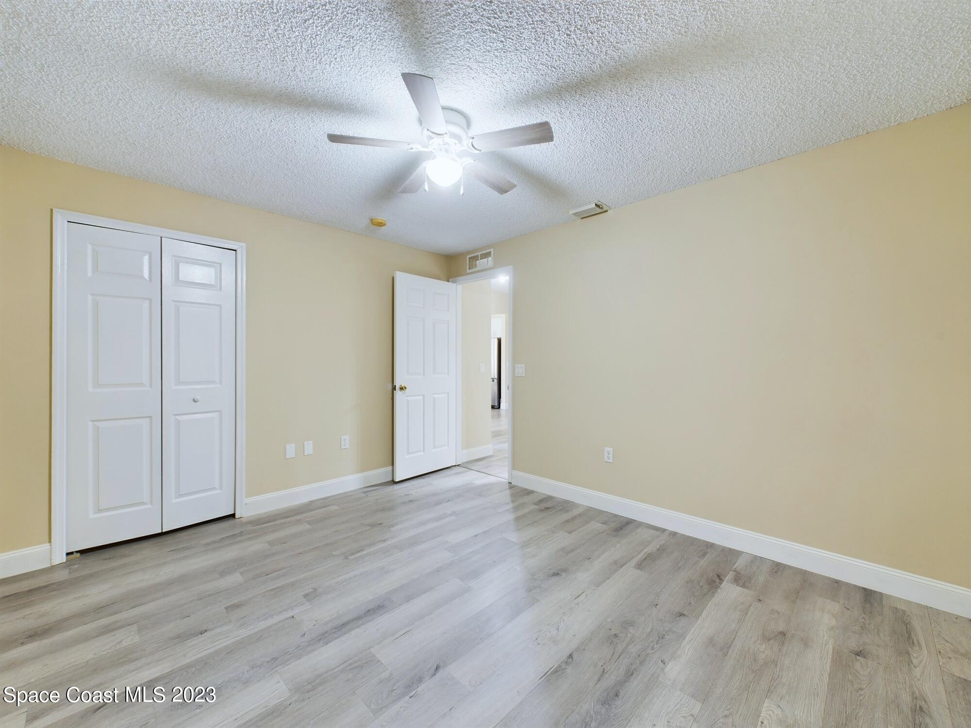 248 Benchor Road Northwest Palm Bay, FL 32907 - Photo 22 of 31 an empty room with wooden floor and windows