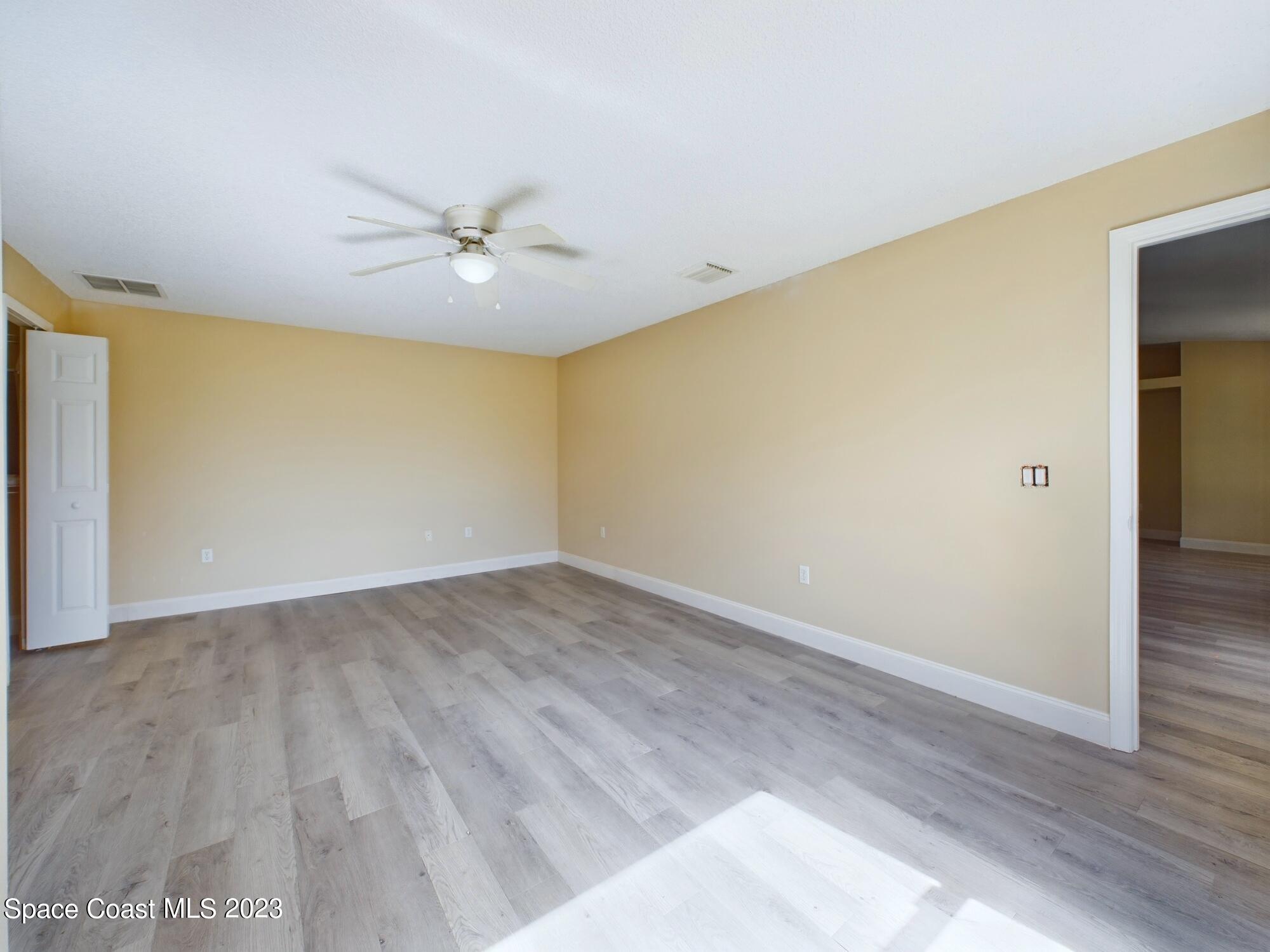 248 Benchor Road Northwest Palm Bay, FL 32907 - Photo 24 of 31 wooden floor in an empty room with a window