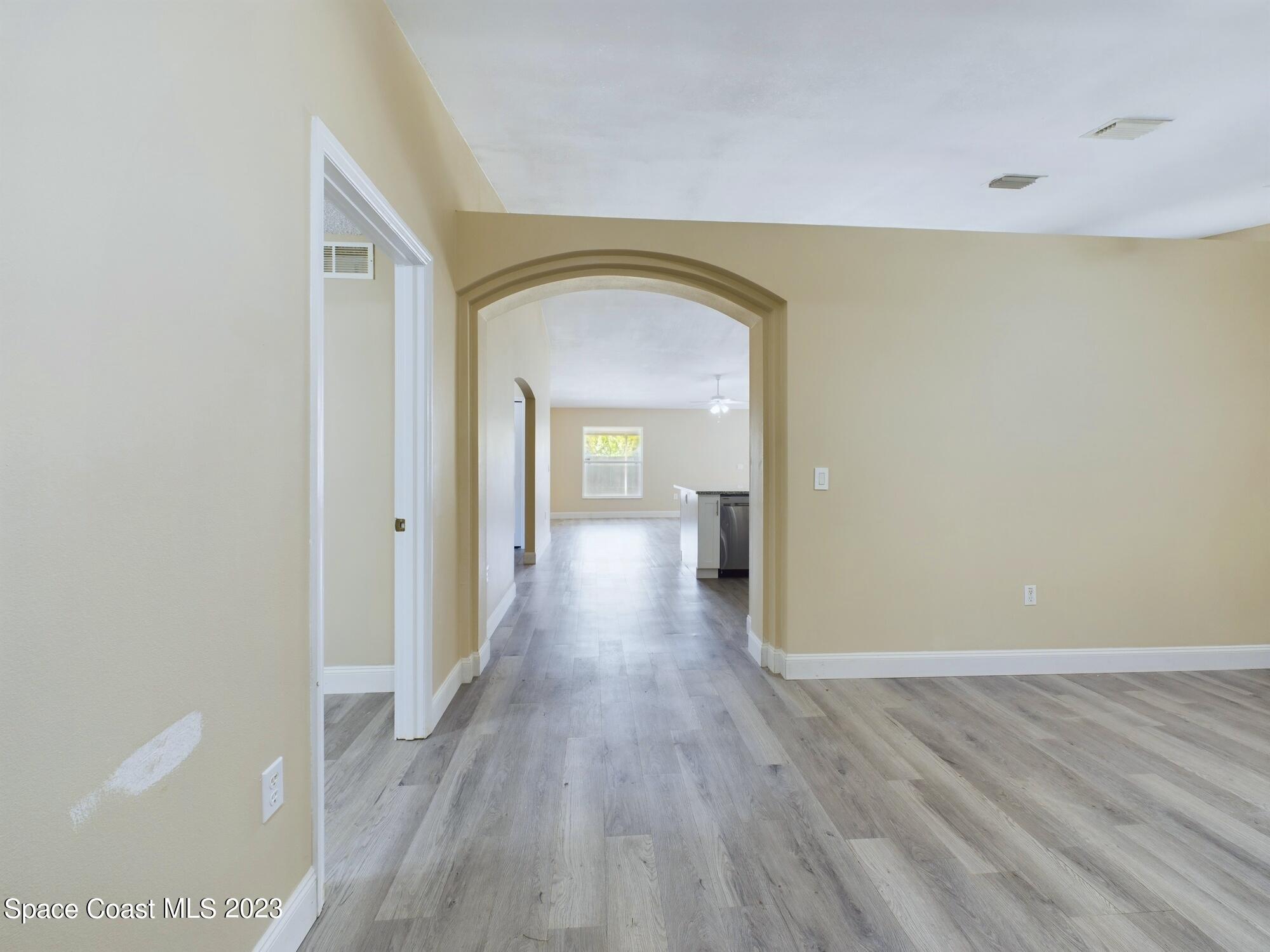 248 Benchor Road Northwest Palm Bay, FL 32907 - Photo 3 of 31 a view of a room with wooden floor