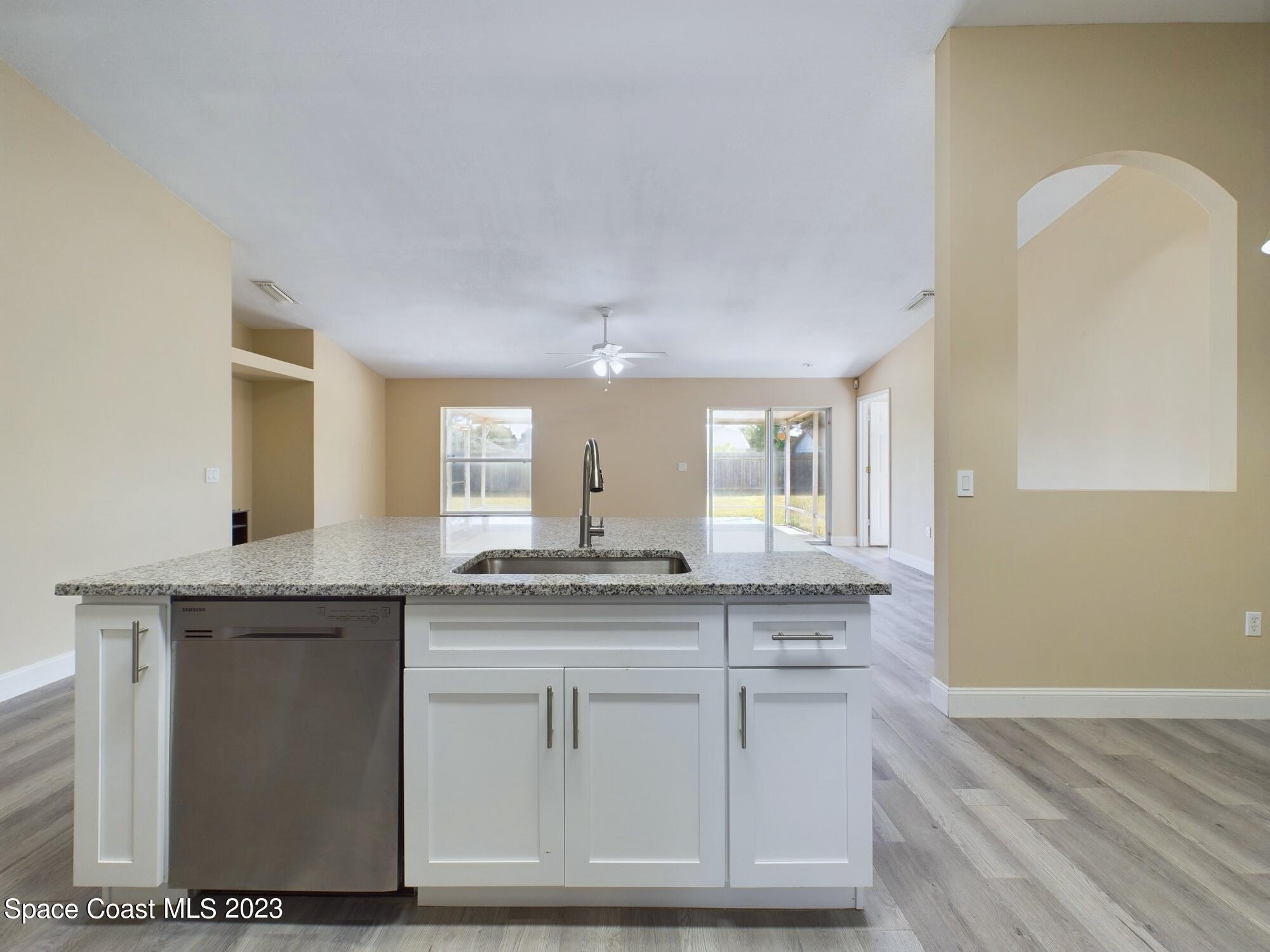 248 Benchor Road Northwest Palm Bay, FL 32907 - Photo 7 of 31 a kitchen with granite countertop a sink and cabinets