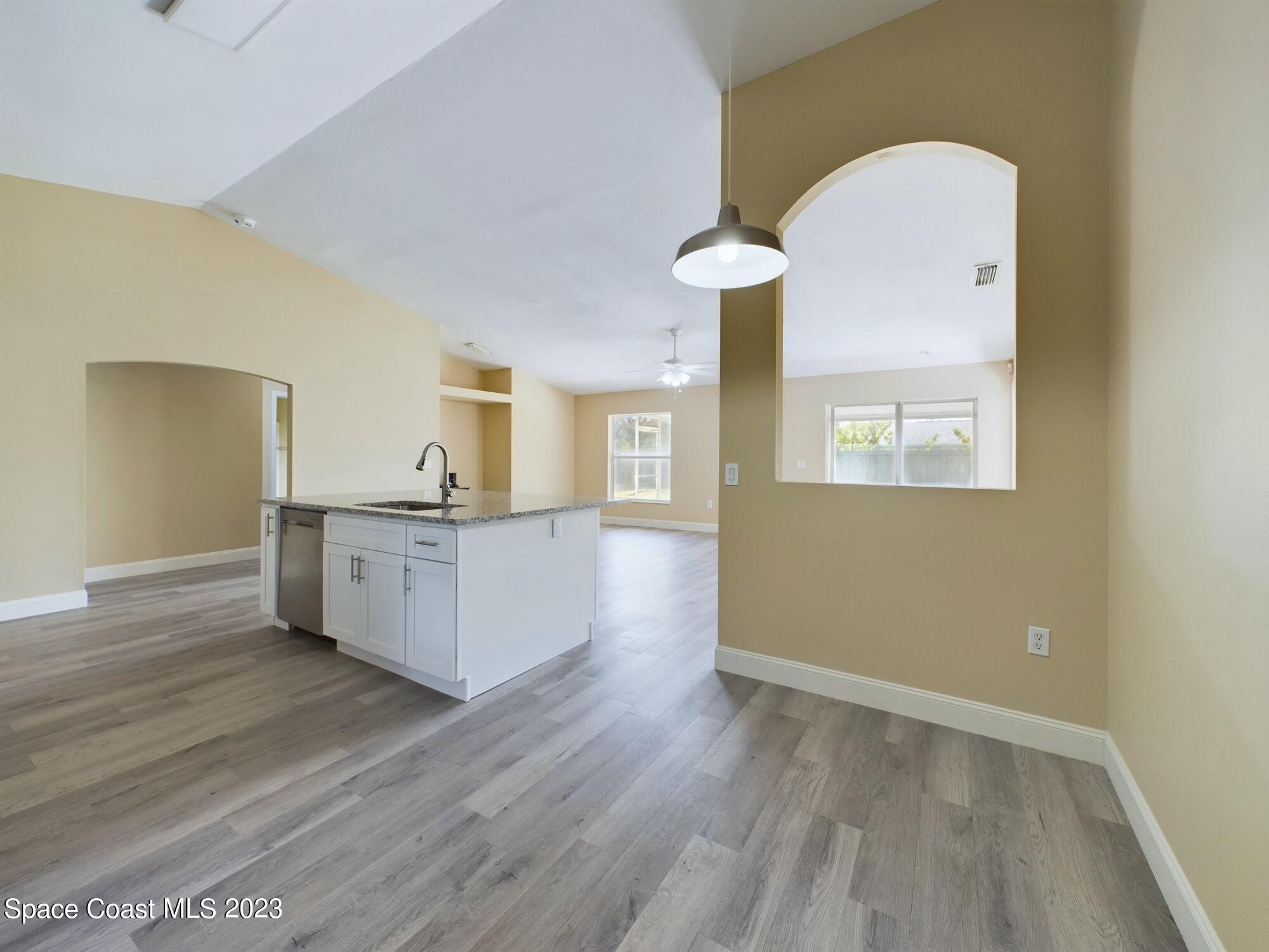 248 Benchor Road Northwest Palm Bay, FL 32907 - Photo 9 of 31 a view of a kitchen cabinets and wooden floor