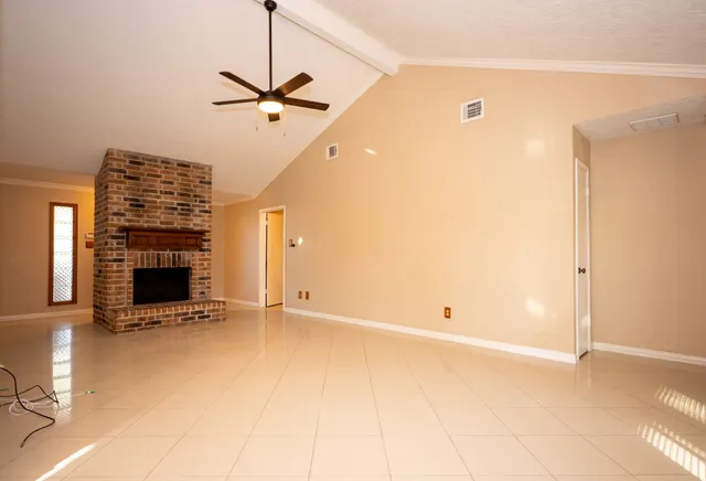 a view of an empty room with a fireplace