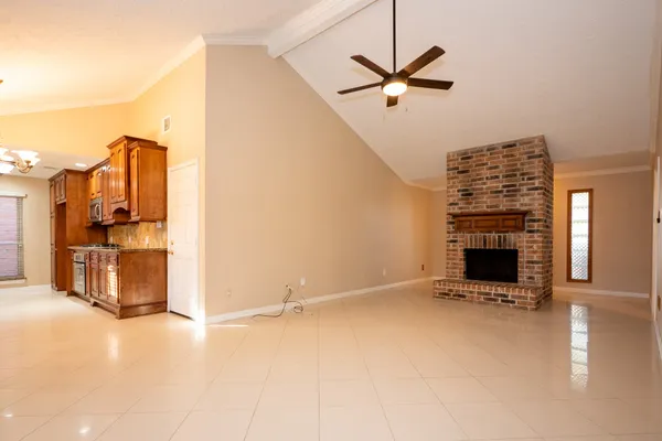 a view of a livingroom with a fireplace and a ceiling fan