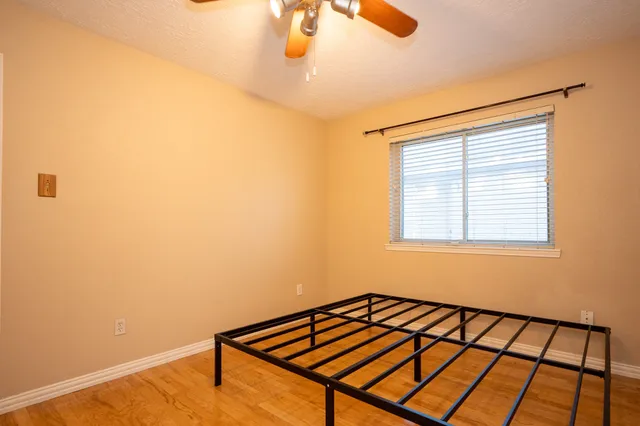 a view of a room with wooden floor and windows