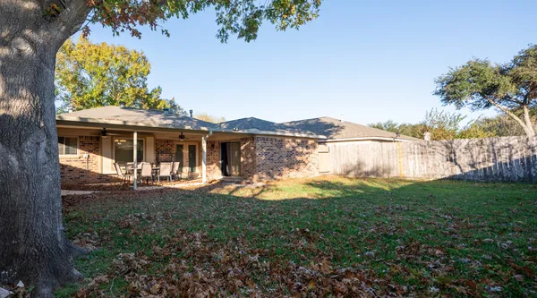 a view of house with garden space and swimming pool