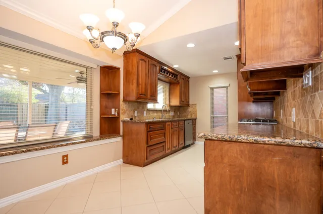 a large kitchen with kitchen island granite countertop a large counter top and stainless steel appliances