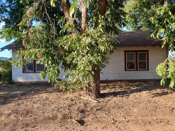 a house with a tree in front of it