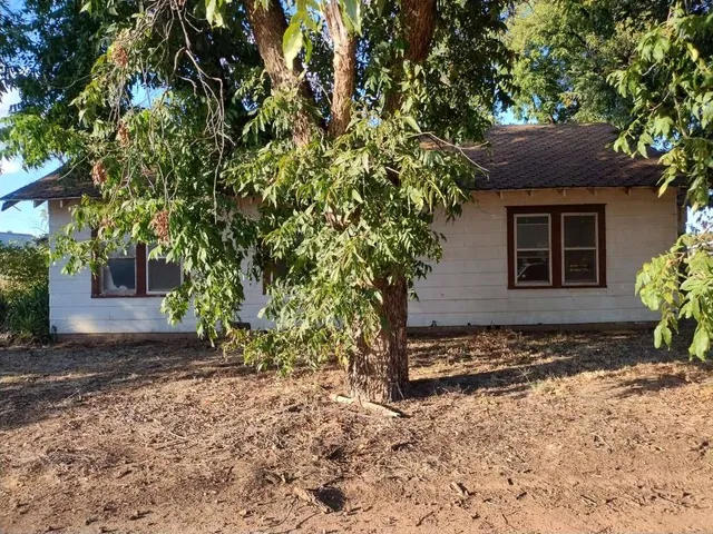 a house with a tree in front of it