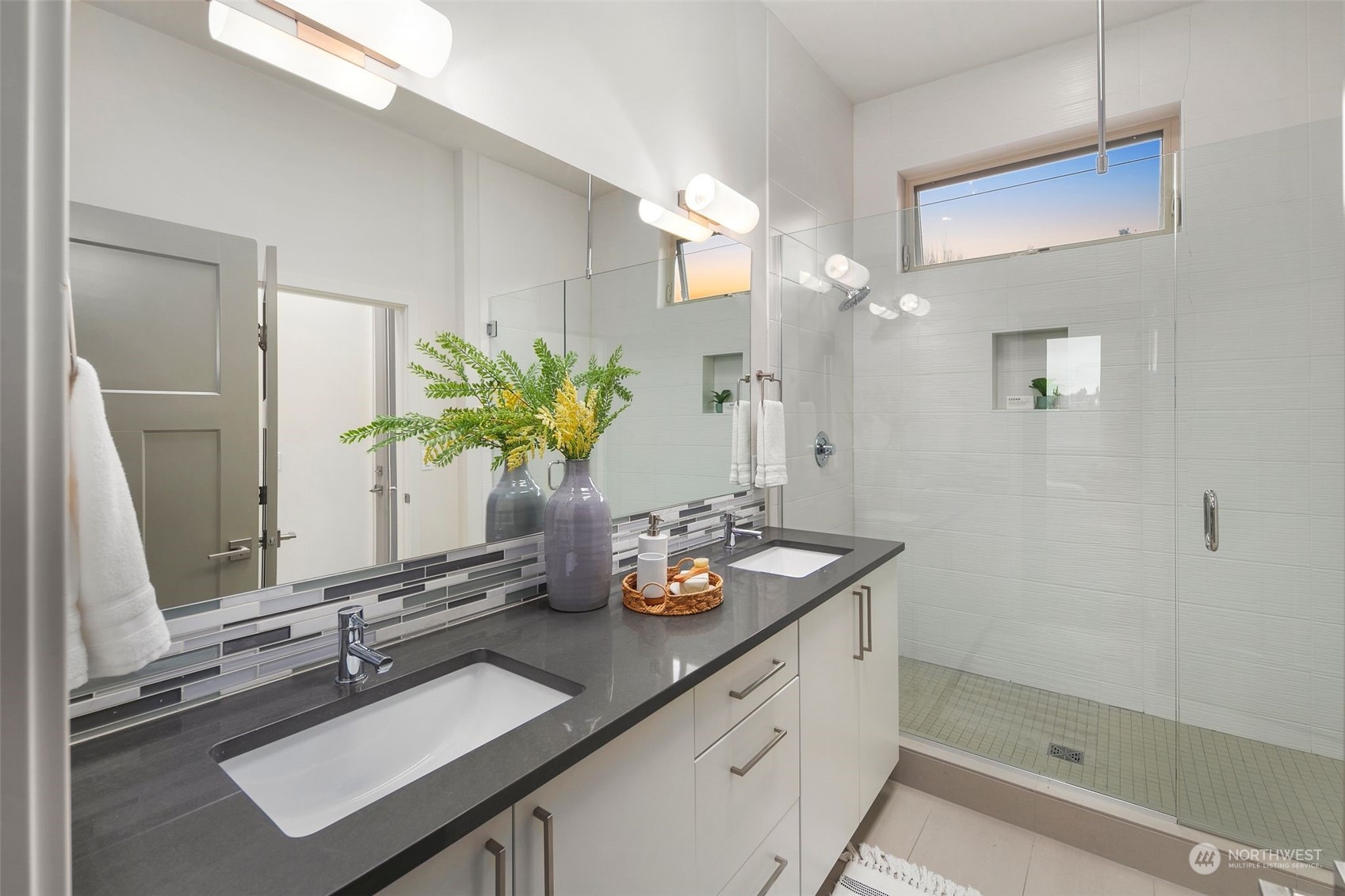 3625 Evanston Avenue North, Unit B Seattle, WA 98103 - Photo 20 of 37 a bathroom with a sink a mirror and a shower