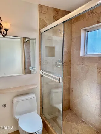 a bathroom with a sink a toilet and mirror