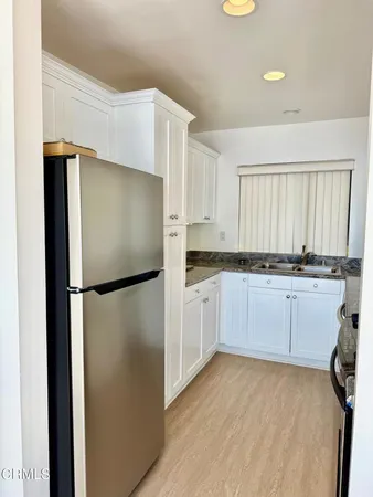 a kitchen with granite countertop a stove and a sink