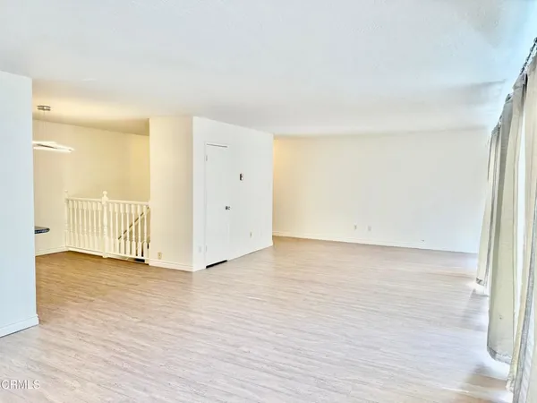 a bedroom with a bed and glass door