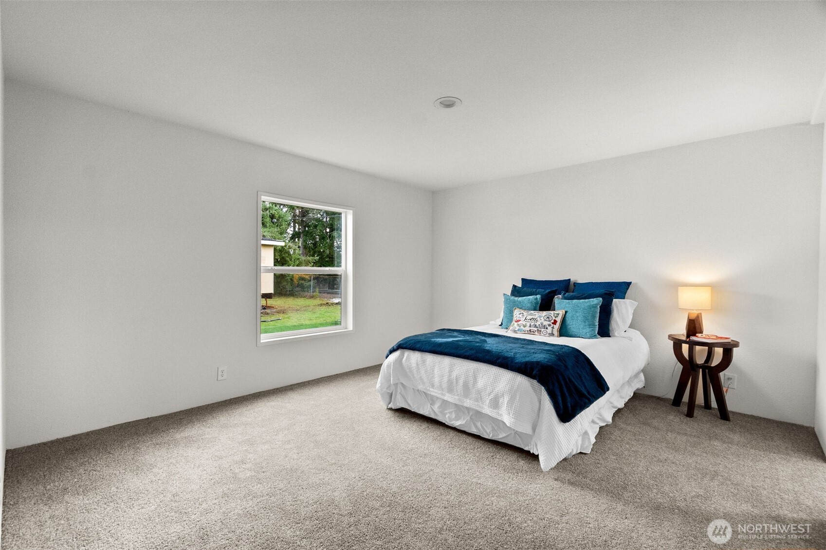 6748 Fir Tree Road Southeast, Unit 15 Olympia, WA 98513 - Photo 16 of 28 a spacious bedroom with a bed and a window