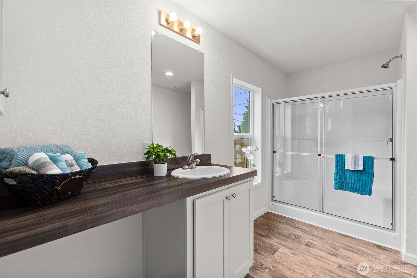 6748 Fir Tree Road Southeast, Unit 15 Olympia, WA 98513 - Photo 19 of 28 a bathroom with a sink and a mirror