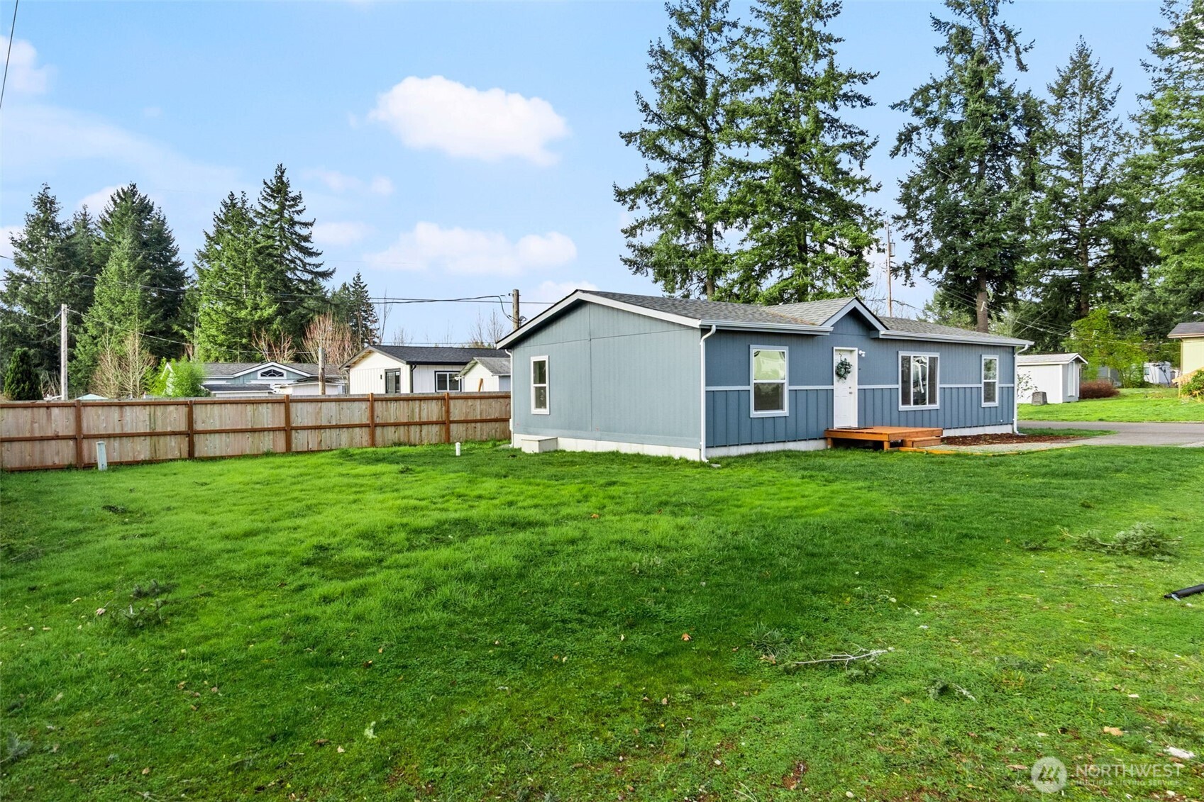 6748 Fir Tree Road Southeast, Unit 15 Olympia, WA 98513 - Photo 25 of 28 a view of a house with a backyard