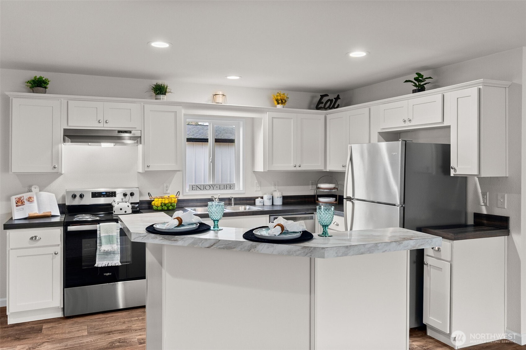 6748 Fir Tree Road Southeast, Unit 15 Olympia, WA 98513 - Photo 8 of 28 a kitchen with a refrigerator a stove a sink dishwasher and white cabinets with wooden floor