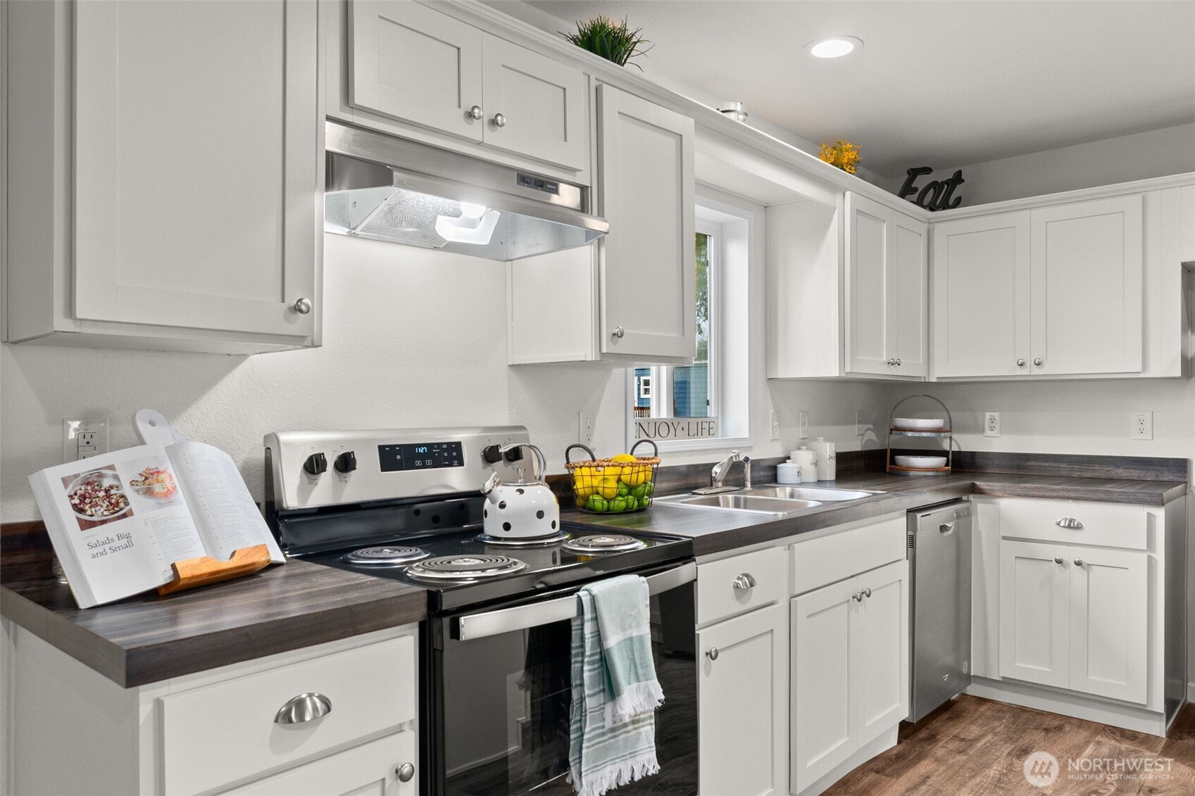 6748 Fir Tree Road Southeast, Unit 15 Olympia, WA 98513 - Photo 9 of 28 a kitchen with stainless steel appliances granite countertop a sink a stove and white cabinets