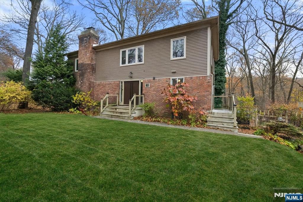 a front view of house with yard and green space