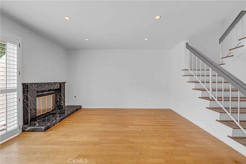 19451 Eagle Ridge Lane Porter Ranch, CA 91326 - Photo 15 of 59 a view of an empty room with wooden floor fireplace and a window