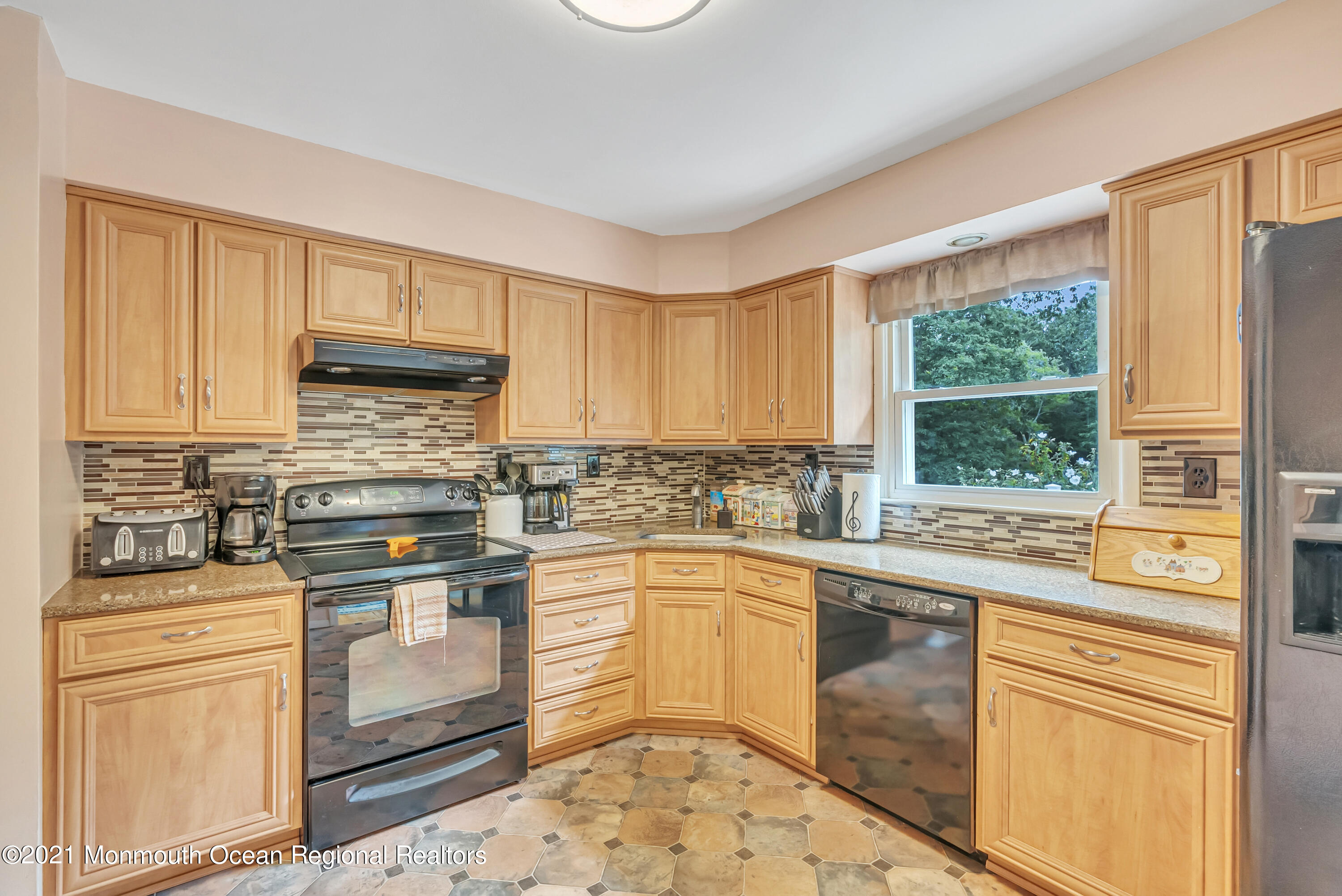 87 Jackson Mills Road Jackson, NJ 08527 - Photo 12 of 32 a kitchen with a stove a sink and a microwave