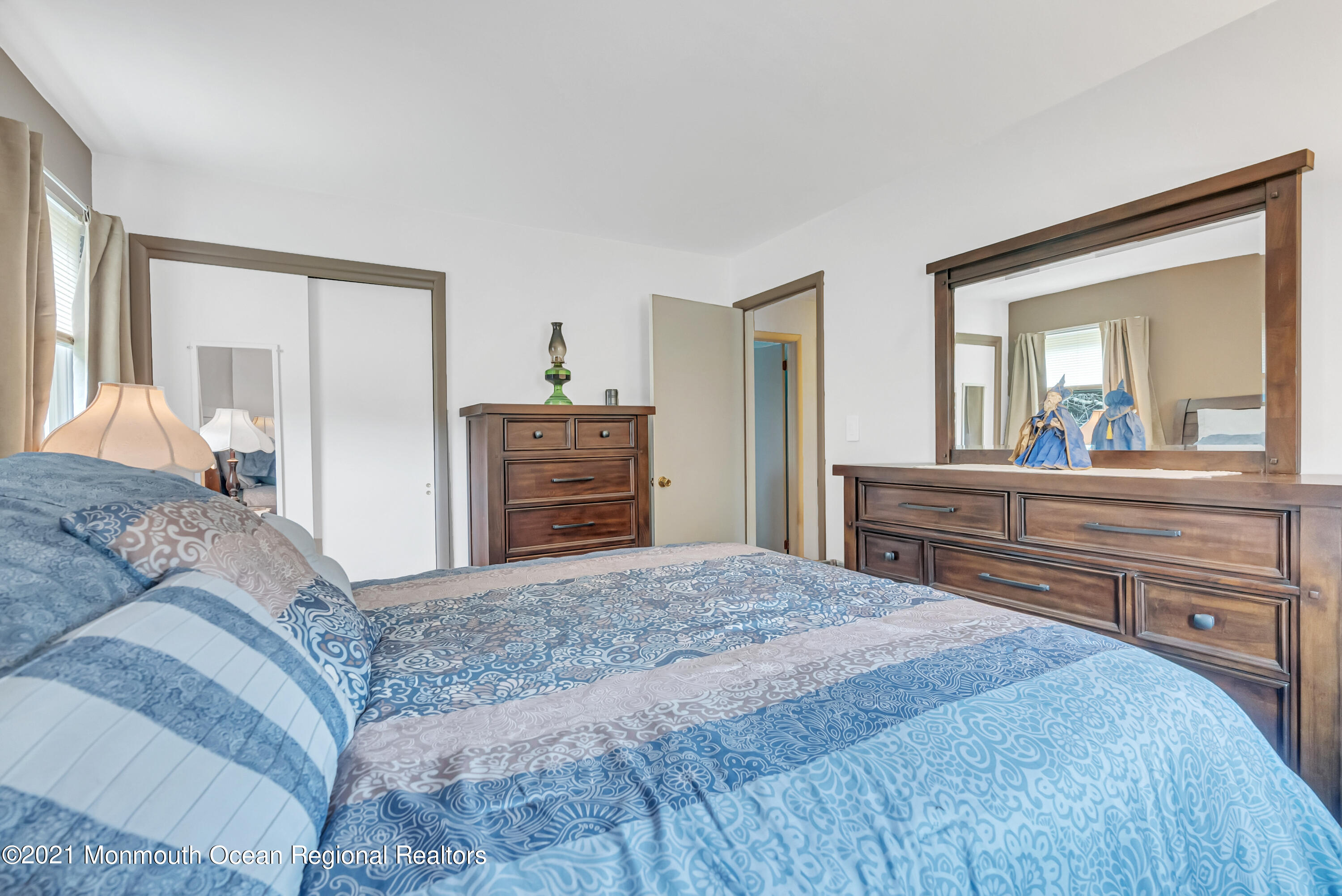 87 Jackson Mills Road Jackson, NJ 08527 - Photo 23 of 32 a bedroom with a large bed and dresser with mirror