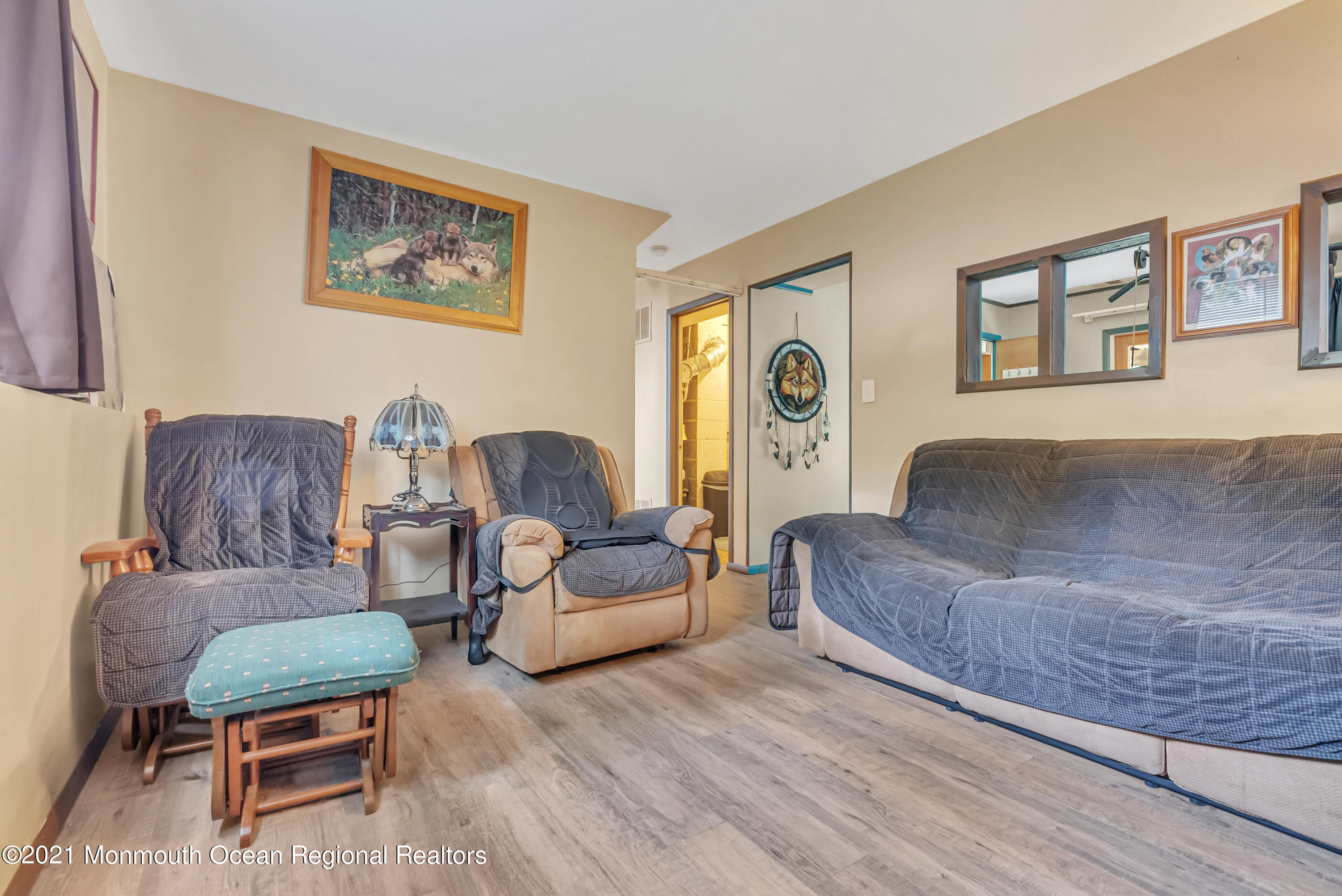 87 Jackson Mills Road Jackson, NJ 08527 - Photo 28 of 32 a living room with couches a coffee table and dresser with wooden floor