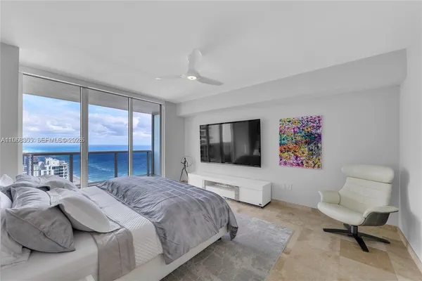 a bedroom with a bed and a flat screen tv