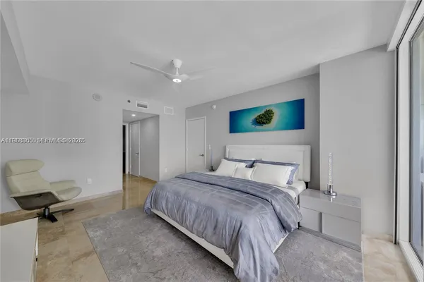 a bedroom with a bed and a television