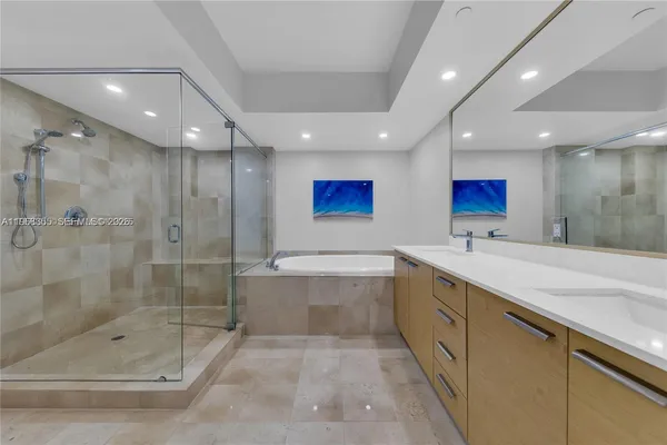 a bathroom with a bathtub and a shower