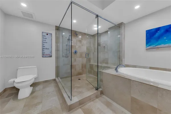 a bathroom with a shower a toilet and sink