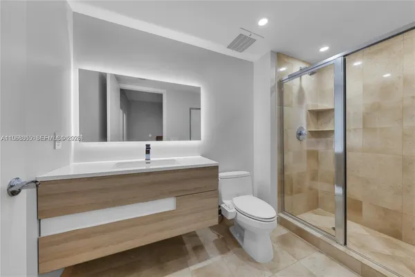 a bathroom with a toilet a sink and a mirror