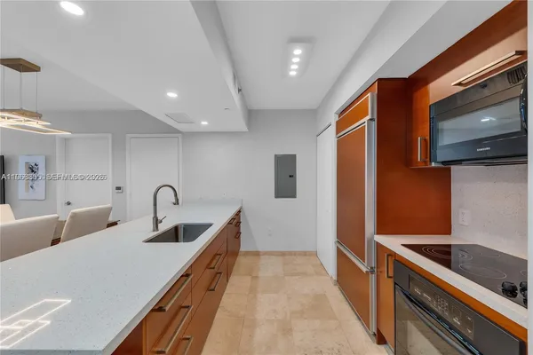 a kitchen with a sink a stove and cabinets