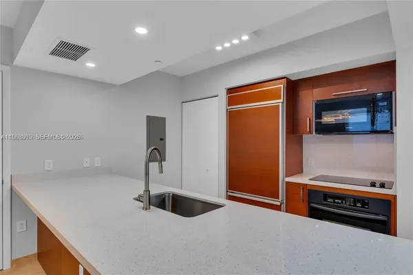 a kitchen with a sink and a refrigerator