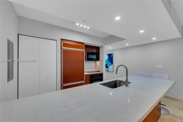 a kitchen with a refrigerator a sink and a refrigerator