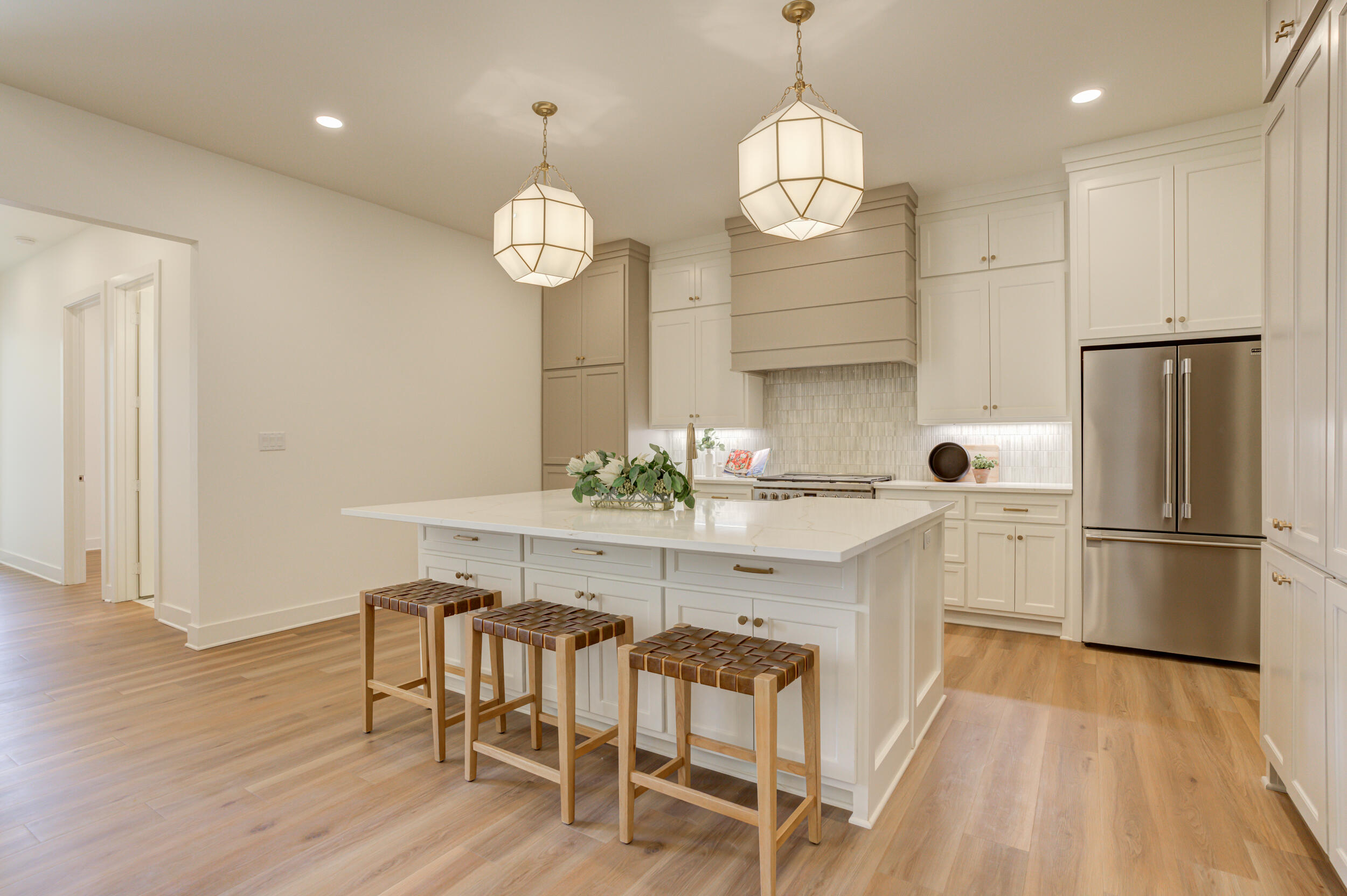 4610 138th Place Lubbock, TX 79424 - Photo 13 of 52 a kitchen with stainless steel appliances granite countertop a dining table chairs refrigerator and wooden floor
